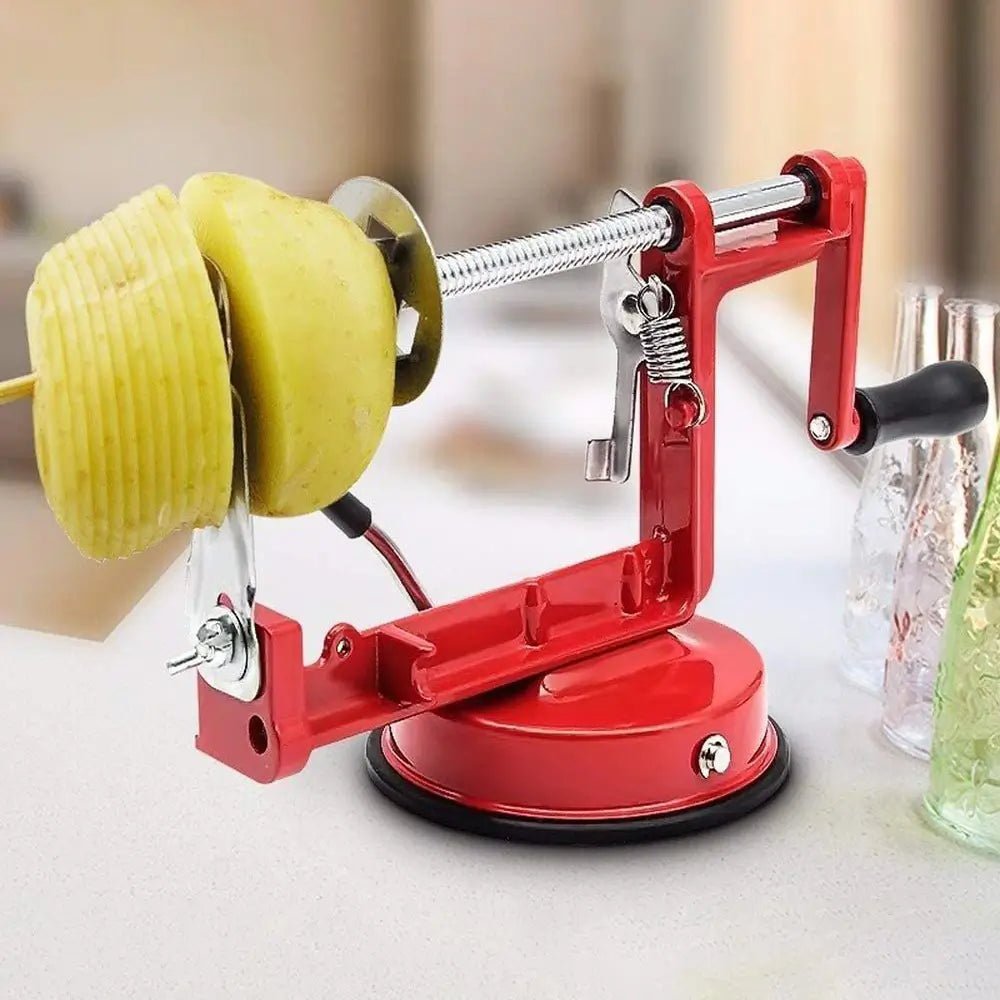 Red spiralizer for vegetables with suction base and black handle shown slicing a peeled apple into thin spirals.