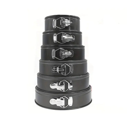 Set of five black metal springform cake pans with silver handles on a white background.
