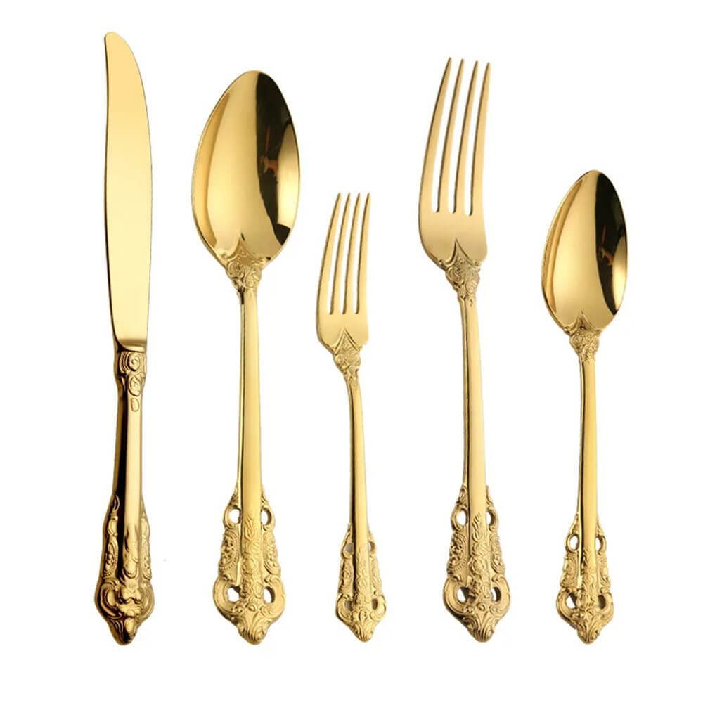 A stainless steel flatware set with a stunning gold finish, including a knife, fork, spoon, salad fork, and teaspoon. Each piece is designed with intricate detailing on the handles, combining durability and elegance, making it an ideal choice for sophisticated dining occasions.