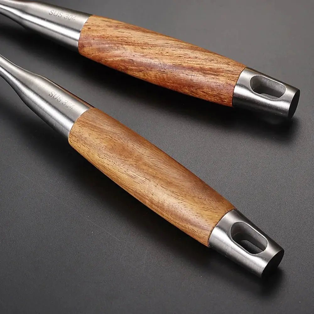 Close-up of wooden handles on stainless steel cooking utensils, showing smooth grip design and durable metal ends for everyday kitchen use.