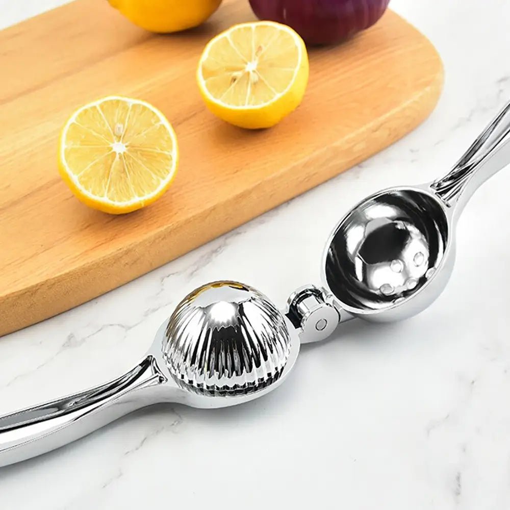 Stainless steel lemon squeezer placed on a marble counter beside sliced lemons on a wooden board, ready for juicing.