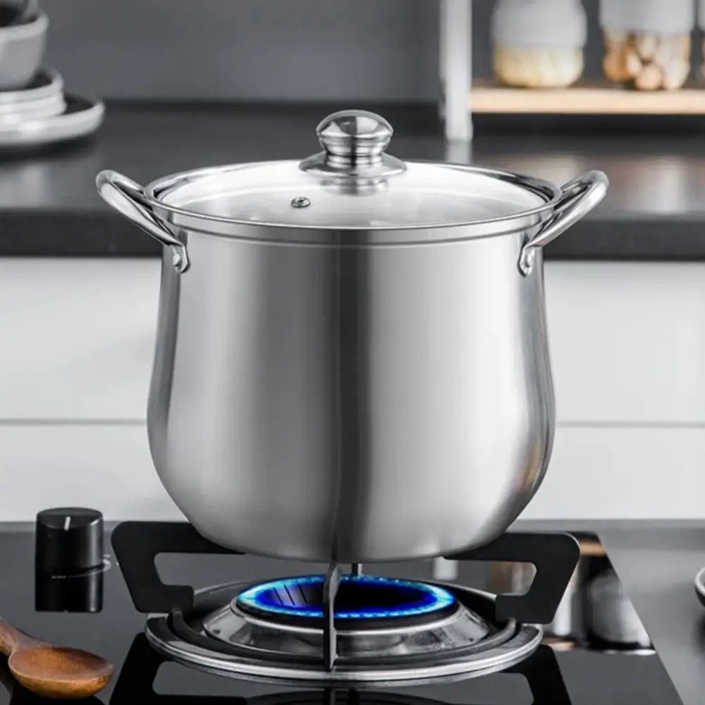 Stainless steel stockpot on a gas stove with a kitchen background