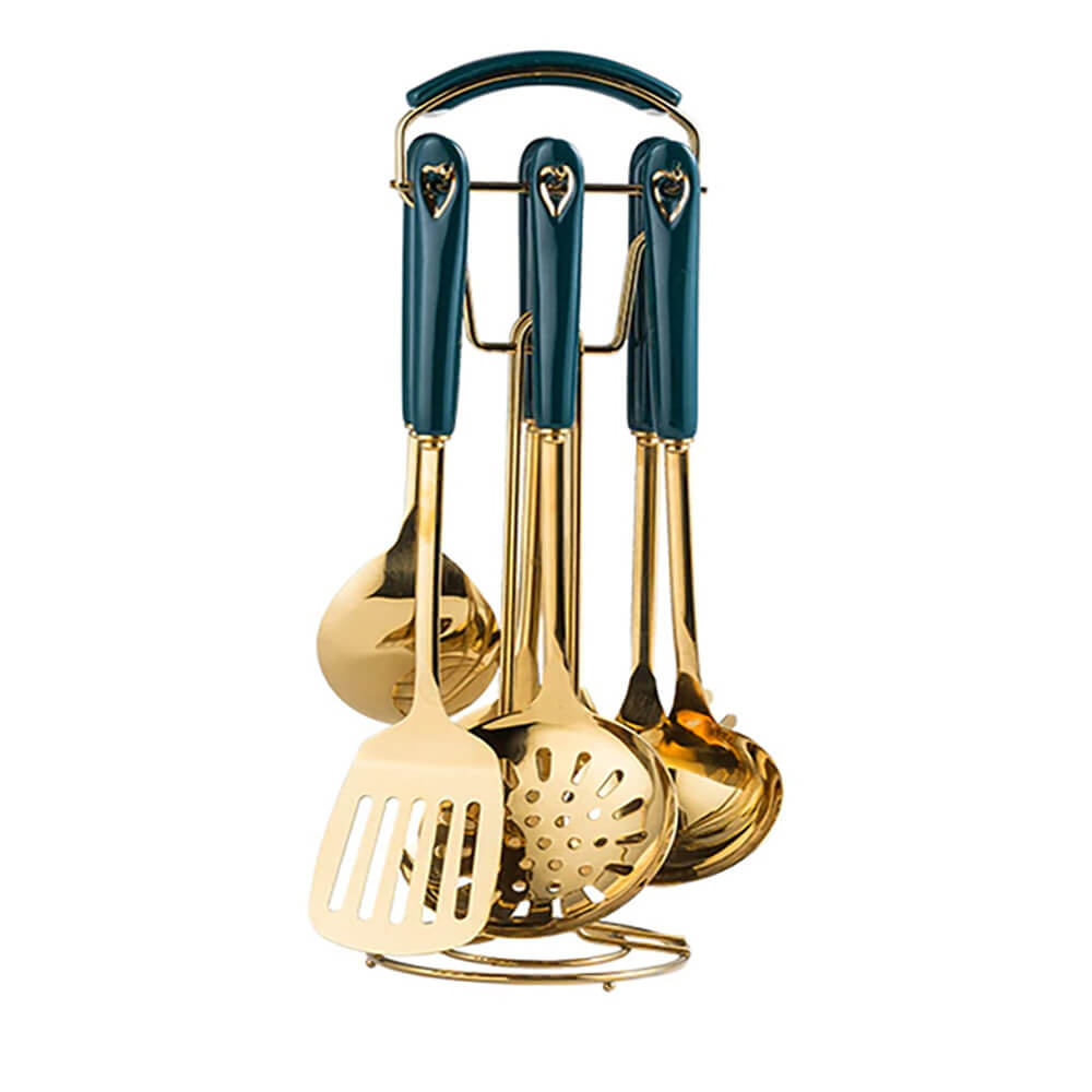 A set of elegant stainless steel utensils with a golden finish, featuring a dark teal handle design. The utensils, including a spatula, ladle, slotted spoon, and skimmer, are neatly arranged on a matching golden stand.