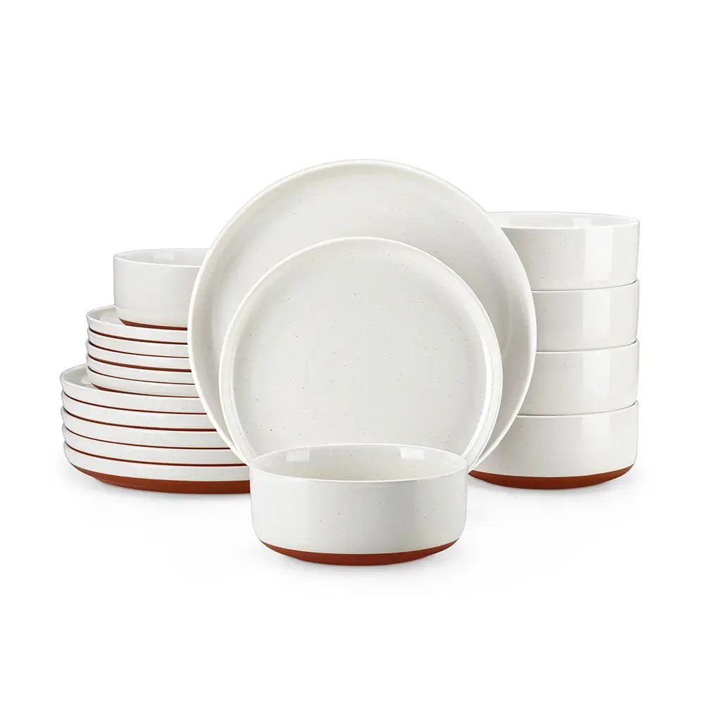 Stoneware dinnerware sets with white plates and bowls featuring a terracotta base, neatly stacked in a full table set.