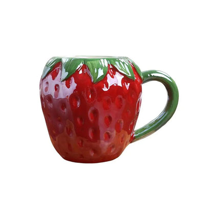 A red strawberry-shaped mug with a detailed design and ergonomic handle, crafted from premium ceramic.