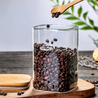 Canisters for flour, sugar, coffee, and tea storage, crafted from glass with bamboo lids.