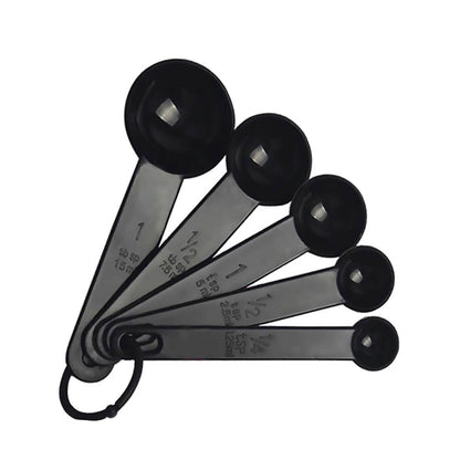 Set of black plastic tablespoon and teaspoon measuring spoons arranged in a fan shape and held together by a small ring.