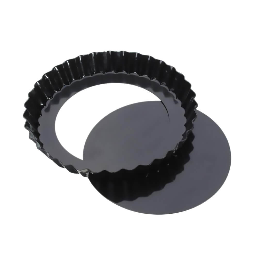 Black fluted tart pan with a removable bottom, designed for easy release and baking precision.