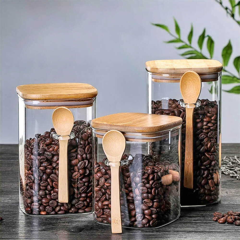 Sets of canisters for tea, coffee, and sugar storage, made from glass with bamboo lids.