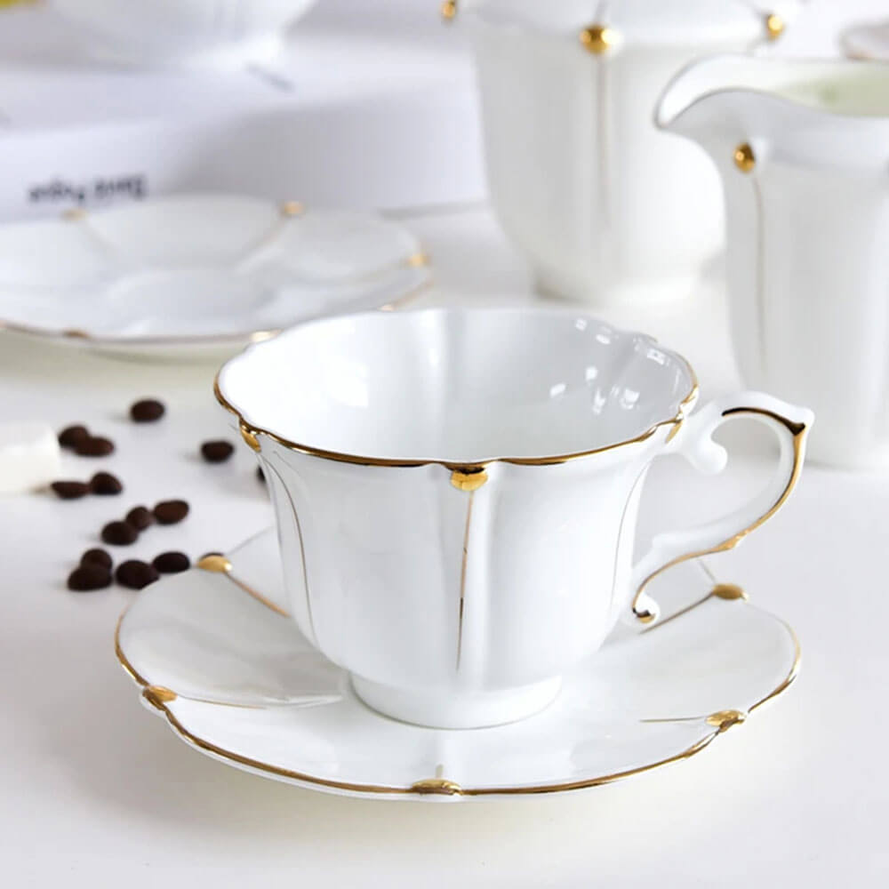 Exquisite white porcelain teacup and saucer with gold detailing, part of a premium tea gift set perfect for elegant tea gatherings and special moments.