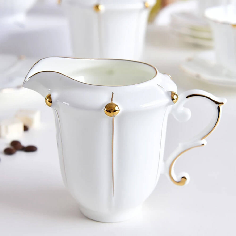 Elegant white creamer with gold accents, a refined piece from a luxurious tea pack gift set, perfect for enhancing tea time gatherings and celebrations.