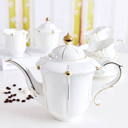 Luxurious white teapot with gold accents, part of an elegant tea pot set that includes matching cups, saucers, and accessories for a refined tea experience.