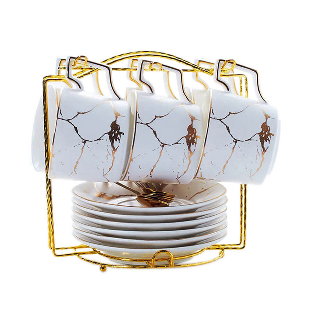 A beautifully organized set of teacups and saucers featuring a marble design with elegant gold accents. The teacups are neatly hung on a gold-tone rack, while the matching saucers are stacked below for a practical yet stylish display.