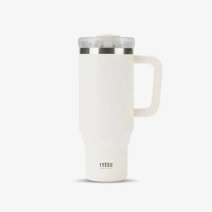 White TYESO thermal travel coffee mug with handle and clear lid on a plain background.