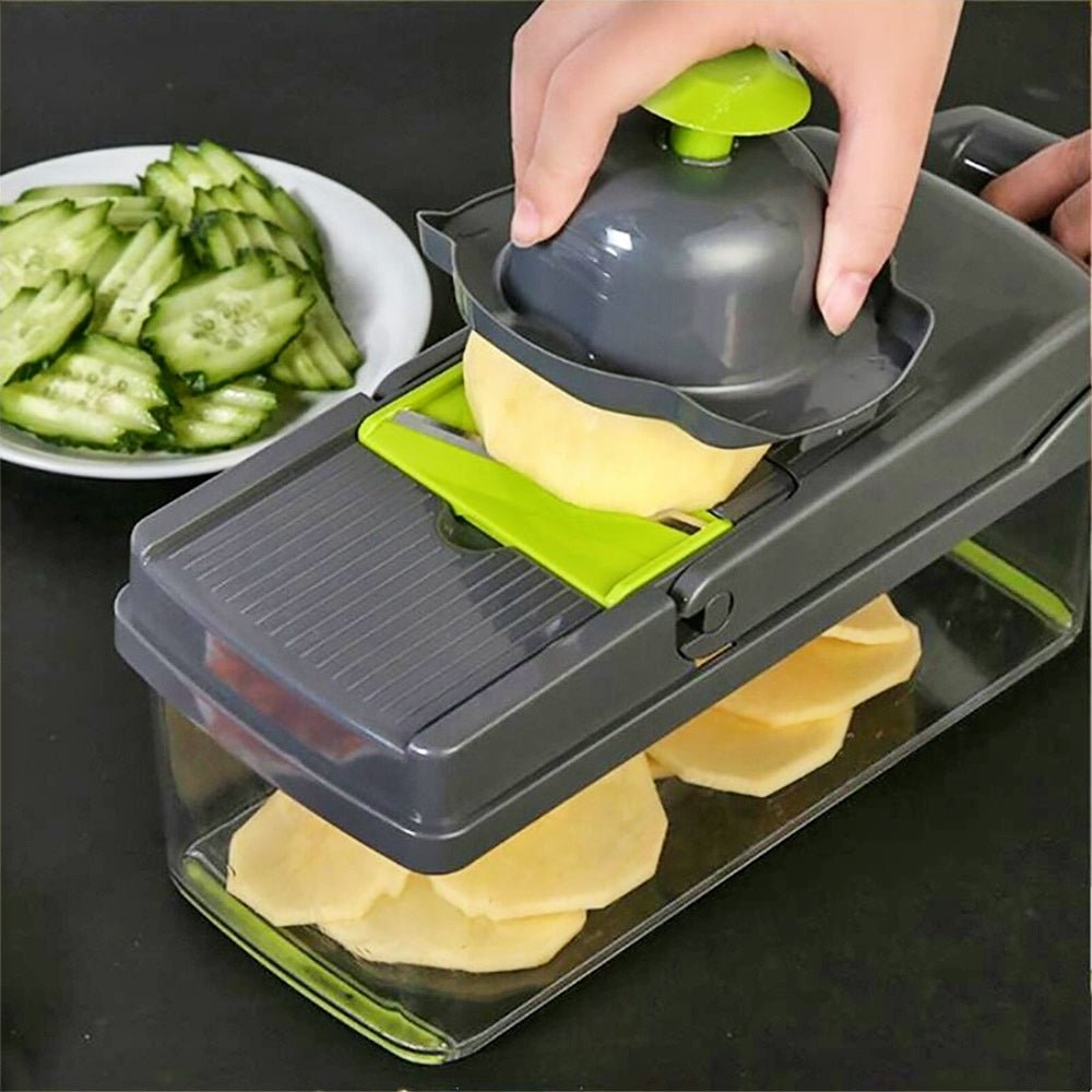 Vegetable grater and slicer slicing potatoes with other vegetables nearby.