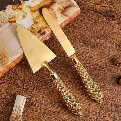 Elegant wedding cake server and knife set with intricate gold details. Ideal for special occasions.