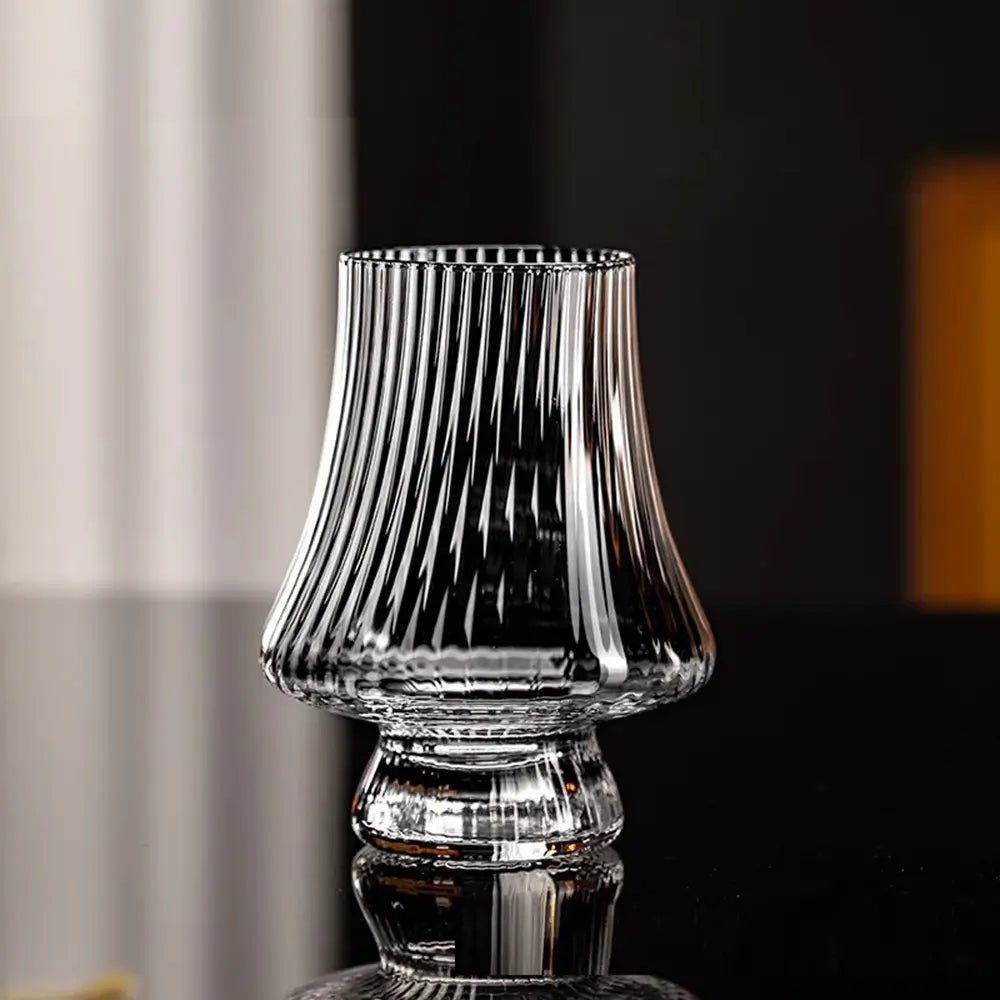 Clear ribbed crystal wine glasses tasting piece with a wide base and flared, tapered bowl, shown on a reflective black surface.