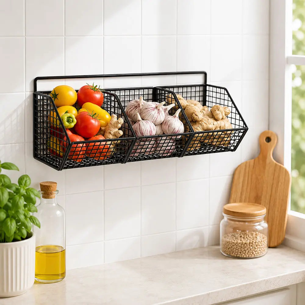 Wire baskets for kitchen storage mounted on a wall, organizing vegetables, garlic, and ginger while saving counter space.